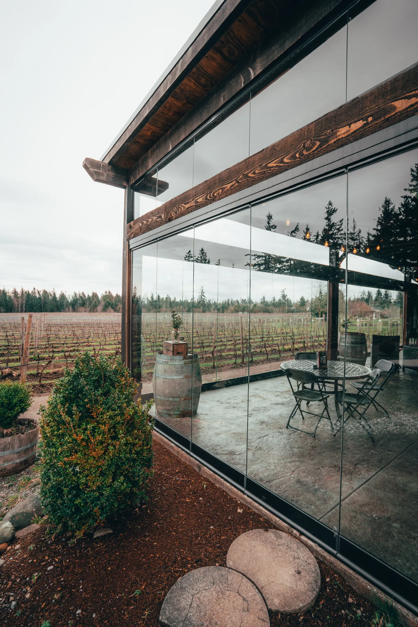 Rain on the pavers outside a glass porch enclosure in late fall